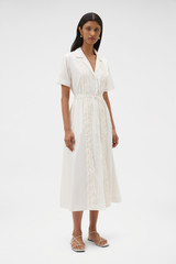 Profile view of model wearing the Oroton Ruffle Detail Shirt Dress in Cream and 100% cotton voile fabric for Women .