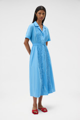 Profile view of model wearing the Oroton Ruffle Detail Shirt Dress in Sea Blue and 100% cotton voile fabric for Women .