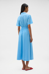 Profile view of model wearing the Oroton Ruffle Detail Shirt Dress in Sea Blue and 100% cotton voile fabric for Women .