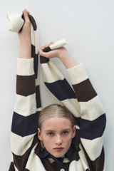 Profile view of model wearing the Oroton Contrast Collar Rugby Knit in Whipped Cream and 100% supersoft merino wool fabric for Women .
