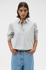 Profile view of model wearing the Oroton Soft Stripe Shirt in Soft Blue and 100% cotton fabric for Women .