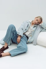 Profile view of model wearing the Oroton Barrel Leg Denim Jean in Light Vintage Wash and 100% cotton fabric for Women .