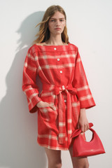 Profile view of model wearing the Oroton Vintage Check Tunic Dress in Ribbon Red and 100% midweight linen fabric for Women .