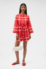 Profile view of model wearing the Oroton Vintage Check Tunic Dress in Ribbon Red and 100% midweight linen fabric for Women .