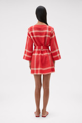 Profile view of model wearing the Oroton Vintage Check Tunic Dress in Ribbon Red and 100% midweight linen fabric for Women .