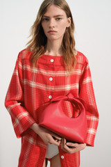 Profile view of model wearing the Oroton Vintage Check Tunic Dress in Ribbon Red and 100% midweight linen fabric for Women .