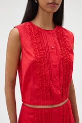 Profile view of model wearing the Oroton Ruffle Detail Top in Red Ribbon and 100% cotton voile fabric for Women .