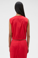 Profile view of model wearing the Oroton Ruffle Detail Top in Red Ribbon and 100% cotton voile fabric for Women .