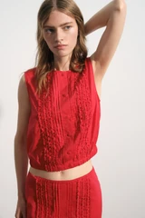 Profile view of model wearing the Oroton Ruffle Detail Top in Red Ribbon and 100% cotton voile fabric for Women .