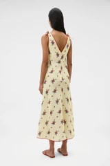 Profile view of model wearing the Oroton Wallpaper Floral Print Dress in Lemon and 100% midweight linen fabric for Women .