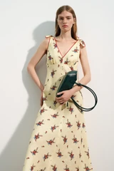 Profile view of model wearing the Oroton Wallpaper Floral Print Dress in Lemon and 100% midweight linen fabric for Women .