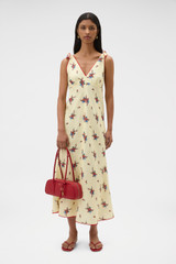 Profile view of model wearing the Oroton Wallpaper Floral Print Dress in Lemon and 100% midweight linen fabric for Women .