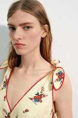 Profile view of model wearing the Oroton Wallpaper Floral Print Dress in Lemon and 100% midweight linen fabric for Women .
