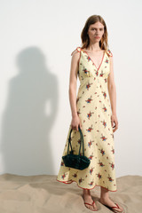 Profile view of model wearing the Oroton Wallpaper Floral Print Dress in Lemon and 100% midweight linen fabric for Women .