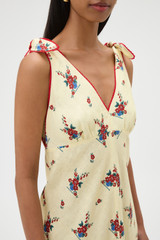 Profile view of model wearing the Oroton Wallpaper Floral Print Dress in Lemon and 100% midweight linen fabric for Women .