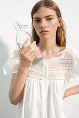 Profile view of model wearing the Oroton Lace Trim Day Dress in White and 100% ramie fabric for Women .