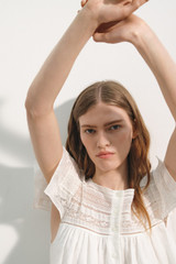 Profile view of model wearing the Oroton Lace Trim Day Dress in White and 100% ramie fabric for Women .