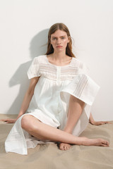Profile view of model wearing the Oroton Lace Trim Day Dress in White and 100% ramie fabric for Women .