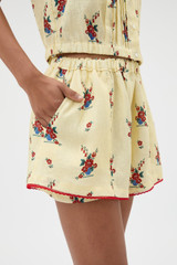 Profile view of model wearing the Oroton Wallpaper Floral Print Short in Lemon and 100% midweight linen fabric for Women .