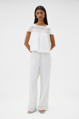 Profile view of model wearing the Oroton Lace Trim Pyjama Pant in White and 100% ramie fabric for Women .