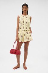 Profile view of model wearing the Oroton Wallpaper Floral Print Top in Lemon and 100% midweight linen fabric for Women .