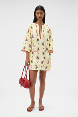 Profile view of model wearing the Oroton Wallpaper Floral Print Tunic Dress in Lemon and 100% midweight linen fabric for Women .