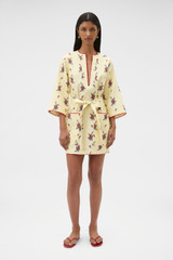 Profile view of model wearing the Oroton Wallpaper Floral Print Tunic Dress in Lemon and 100% midweight linen fabric for Women .