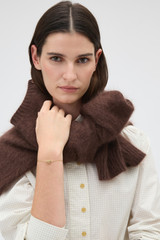 Profile view of model wearing the Oroton Julia Knot Bracelet in Gold and Premium brass material for Women .