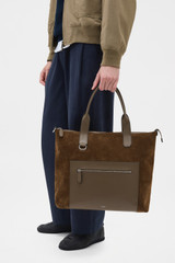Profile view of model wearing the Oroton Paxton Suede Tote in Husk Brown and Premium Grade A velvet-finish cow suede leather for Men .