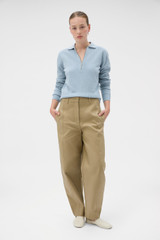 Profile view of model wearing the Oroton Tailored Curved Leg Pant in Haystack and 100% cotton fabric for Women .