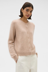 Profile view of model wearing the Oroton Cashmere Blend Cardigan in Biscotti and 70% ultra fine merino wool and 30% cashmere blend fabric for Women .