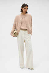 Profile view of model wearing the Oroton Cashmere Blend Cardigan in Biscotti and 70% ultra fine merino wool and 30% cashmere blend fabric for Women .