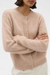 Profile view of model wearing the Oroton Cashmere Blend Cardigan in Biscotti and 70% ultra fine merino wool and 30% cashmere blend fabric for Women .