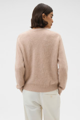 Profile view of model wearing the Oroton Cashmere Blend Knit in Biscotti and 	
70% ultra-fine merino wool and 30% cashmere blend fabric for Women .