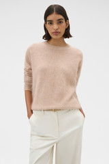 Profile view of model wearing the Oroton Cashmere Blend Knit in Biscotti and 	
70% ultra-fine merino wool and 30% cashmere blend fabric for Women .