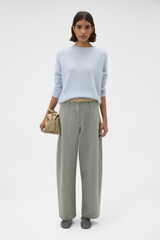Profile view of model wearing the Oroton Cashmere Blend Knit in Soft Blue and 	
70% ultra-fine merino wool and 30% cashmere blend fabric for Women .