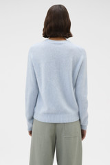 Profile view of model wearing the Oroton Cashmere Blend Knit in Soft Blue and 	
70% ultra-fine merino wool and 30% cashmere blend fabric for Women .