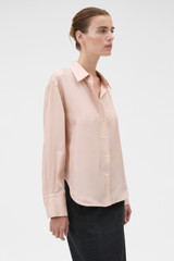 Profile view of model wearing the Oroton Long Sleeve Shirt in Rose Tint and 100% silk habotai fabric for Women .