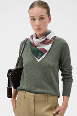 Profile view of model wearing the Oroton The Swimmer Scarf in Olive and 100% silk twill fabric for Women .