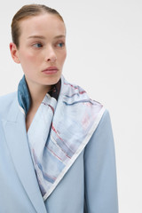 Profile view of model wearing the Oroton The Schoolboy Scarf in Smoke Blue and 100% silk twill fabric for Women .