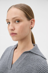 Profile view of model wearing the Oroton Heather Enamel Hoops in Black and Premium brass material for Women .