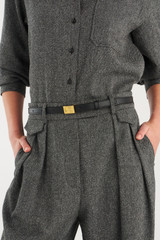 Profile view of model wearing the Oroton Yvonne Narrow Belt in Black and Premium pebble leather for Women .