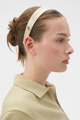 Profile view of model wearing the Oroton Daphne Headband in Shell/Brass and Acetate and brass material for Women .