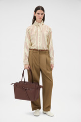 Profile view of model wearing the Oroton Cleo Smooth Work Tote in Treacle and Premium smooth leather for Women .