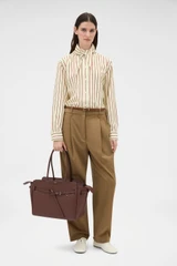 Profile view of model wearing the Oroton Cleo Smooth Work Tote in Treacle and Premium smooth leather for Women .