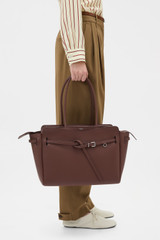 Profile view of model wearing the Oroton Cleo Smooth Work Tote in Treacle and Premium smooth leather for Women .