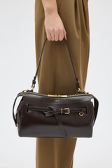 Profile view of model wearing the Oroton Cleo Crackle Shoulder Bag in True Chocolate and Premium crackle leather for Women .