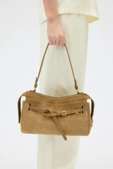 Profile view of model wearing the Oroton Cleo Suede Shoulder Bag in Tobacco and Premium suede leather for Women .