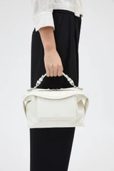 Profile view of model wearing the Oroton Mica Smooth Bowler in Warm White and Premium smooth leather for Women .