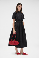Profile view of model wearing the Oroton Belted Shirt Dress in Black and 100% cotton poplin fabric for Women .